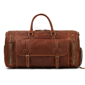 Front view of a dark brown crazy horse leather travel bag with buckle pockets and zippers