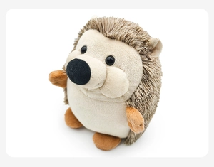 Close-up of cute plush hedgehog toy with brown faux quills and soft white fabric