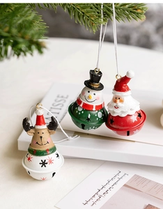Christmas bell ornaments featuring Santa Snowman and Reindeer on a pine branch