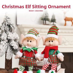 Macro detail of plush Christmas elf dolls with striped hats and cozy holiday outfits