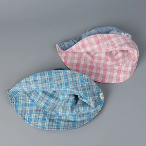 Detail view of denim bucket hat showing pink and blue plaid cotton lining