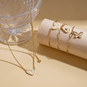 Golden heart pendant necklace and bracelets set with textured crushed diamond finish