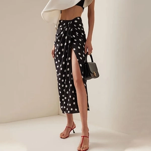 Detail view of polka dot high slit maxi skirt with elegant wrap design and light chiffon fabric