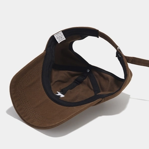 Inside view of a brown cotton ponytail sun visor with embroidery and sweatband