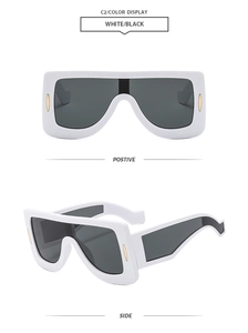 Front and side views of matte white oversized futuristic sunglasses with gold accents