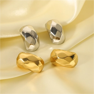 Irregular faceted 18k gold and silver stainless steel earrings on beige silk