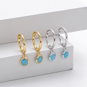 Detailed view of S925 sterling silver hoop earrings with blue stones in gold and silver
