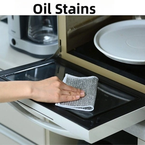 Detail showing non-scratch silver wire cloth cleaning oil stains inside a microwave oven