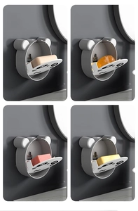 Detail of wall-mounted panda ear soap holders showing drainage and flip-top lid design