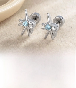 Detailed view of silver starfish and shell stud earrings with blue zircon and flat back