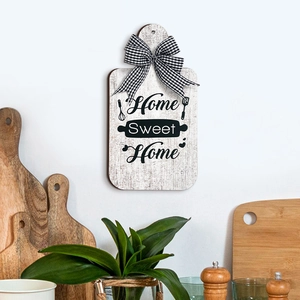 Detail of Home Sweet Home wooden cutting board sign with a black and white gingham bow