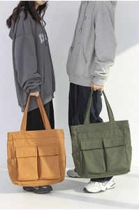 Comparison of earth yellow and army green canvas tote bags with multi-pocket details
