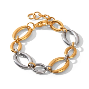 Detail of two-tone gold and silver oval chain bracelet with polished finish and lobster clasp