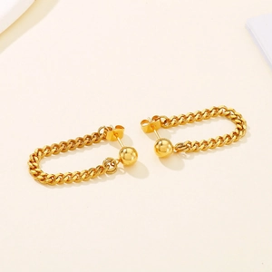 Detail of golden stainless steel stud earrings with Cuban link chain tassel design
