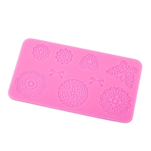 Pink silicone mold featuring butterflies and flowers for fondant and cake decorating