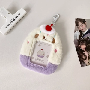 Detail of plush cream and purple cake-shaped card holder with cherry charm and hook