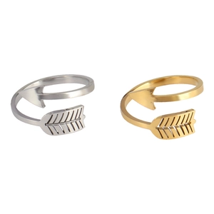 Detail of minimalist arrow rings in silver and gold with engraved feather textures