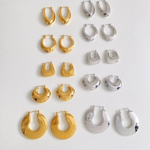 Multiple pairs of gold and silver hollow metal earrings in various geometric shapes
