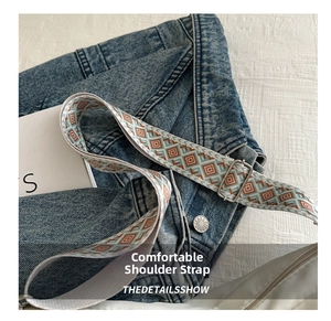 Detail of adjustable jacquard strap with orange and blue geometric rhombus patterns