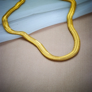 Detailed close-up of chunky gold and silver punk style dual-tone chain necklace