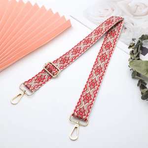 Detail of bohemian red and grey geometric woven canvas strap with gold metal hooks