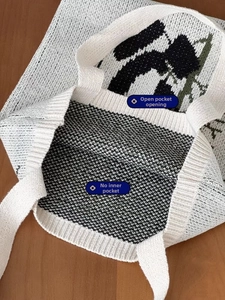 Detail of knit panda tote bag with open top design and no interior pocket