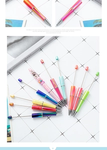 Vibrant DIY beaded ballpoint pens with UV gradient finishes arranged in a fan shape