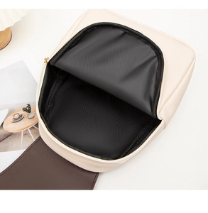 Detailed top view showing the spacious interior and dark lining of the cream PU backpack
