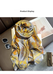 Detail of silk satin scarf with golden Baroque prints and luxury fashion accessories