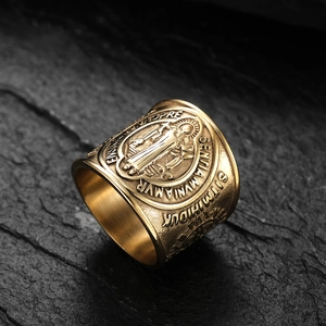 Saint Benedict Medal ring in vintage gold stainless steel shown on dark stone background