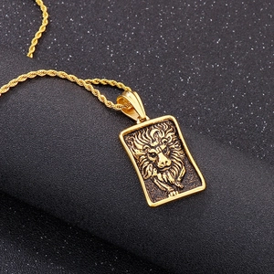 Détail du relief de tête de lion doré sur pendentif rectangulaire avec chaîne torsadée
