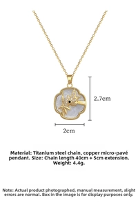 Close-up of golden bird and bamboo pendant with diamonds measuring 2.7x2cm on chain