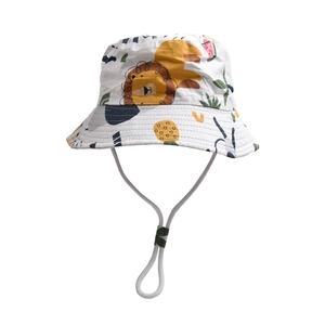 Detail of children's cotton bucket hat with cute lion and tropical plant prints