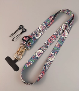Detail of adjustable crossbody phone strap featuring vintage floral fabric and gold clips