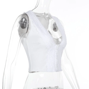 Dettaglio ravvicinato del patchwork in pizzo bianco e del design traforato sul top corto
