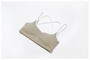 Detail of cross-back straps and elastic hem on khaki high-elasticity sports bra