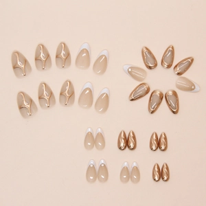 Detail view of almond French press-on nails with 3D gold accents and pearl details