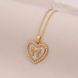 Vintage heart pendant necklace with pearls and gold bow on high-quality steel chain