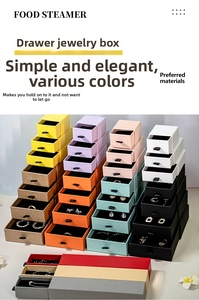 Macro view of colorful sliding drawer jewelry boxes with black flocked velvet interior