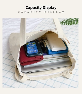 Top view of spacious cream canvas tote bag showing interior capacity and daily items