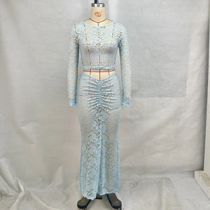 Detail of light blue lace two-piece set featuring floral crochet and ruched skirt design