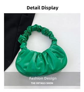 Close-up of vibrant green pleated shoulder bag with soft faux leather texture details