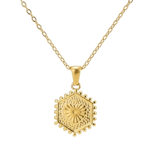 Close-up of golden 18K stainless steel hexagonal pendant with heart sunburst engraving