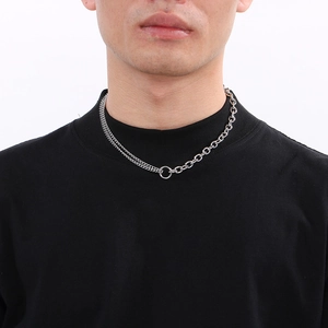 Detail of silver stainless steel necklace with O-chain and Cuban link splicing on neck