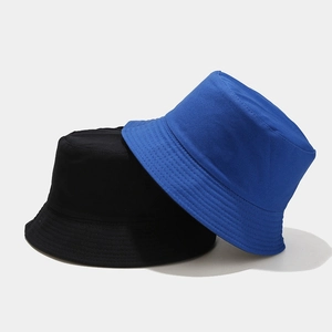 Detail of black and navy blue double-sided cotton bucket hats with reinforced stitching