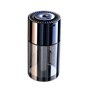 Modern cylindrical car aromatherapy diffuser with dark metallic top and USB-C port