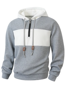 Detail of grey color block hoodie with waffle texture fabric and half-zip collar