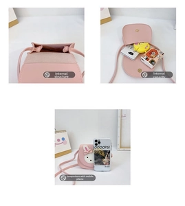 Detail showing inner capacity and size comparison of pink rabbit kids crossbody bag
