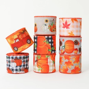 8 rolls of Thanksgiving ribbons with pumpkin and maple leaf patterns on white background