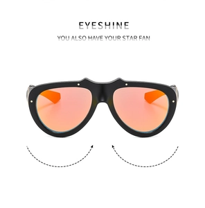 Detail of oversized sports sunglasses with black frames and orange mirrored lenses
